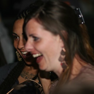 Two Women Laughing Together at Nighttime Event