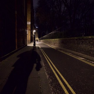 Shadow Figure on Empty London Street at Night