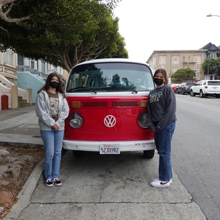 Friends Posing with Classic Red Volkswagen Van