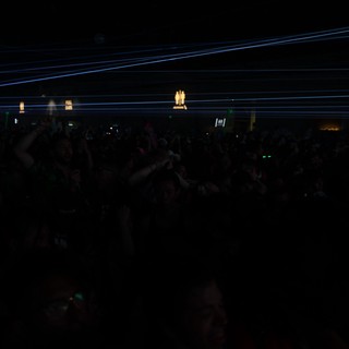 Electric Blue Laser Grid Over Dark Festival Crowd
