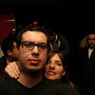 Two Friends Pose at a Dimly Lit Nightclub