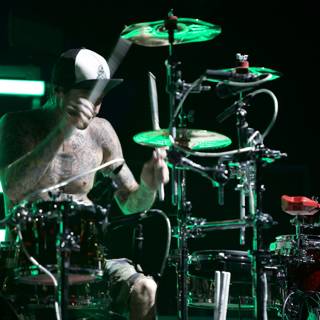 Drumming Tattooed Performer Shining on Stage