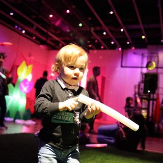 Toddler with Light Stick at Baby Rave Event