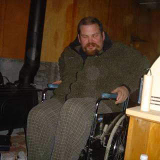 Wheelchair-bound Flea F poses with favorite armchair