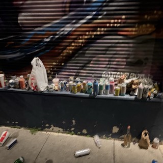Street Tailor's Colorful Thread Collection at Night