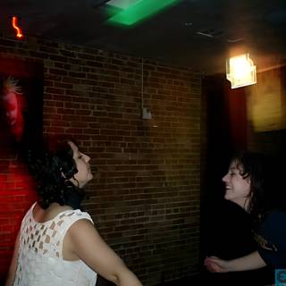 Spotlight on Two Women Dancing in a Nightclub