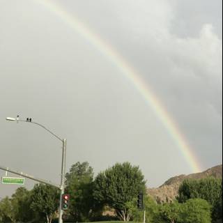 Rainbow over the Streetlight and Hill