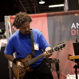 Man playing an electric guitar at 2008 NAMM concert