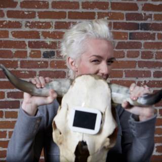 Woman poses with cow skull