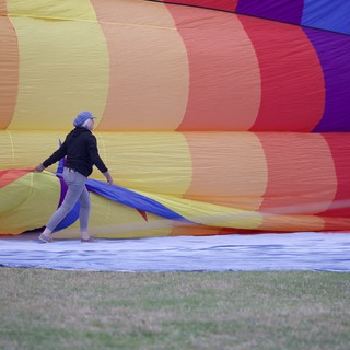 Ground Crew Wrestles Rainbow Balloon Into Life
