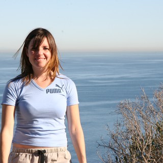 Smiling Woman at Coastal Overlook with Ocean View