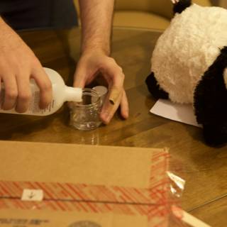 Pouring liquid into bottle of panda
