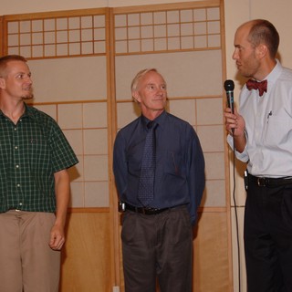 Three Men at Wedding Reception with Microphone