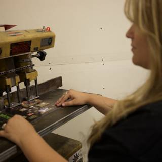 Woman Operating Machine in Manufacturing Facility