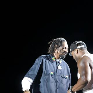Two Men on Stage with Snoop Dogg