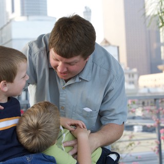 Father Shares Tender Moment With Two Young Sons