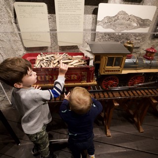Young Brothers Exploring Vintage Train Exhibit at Museum