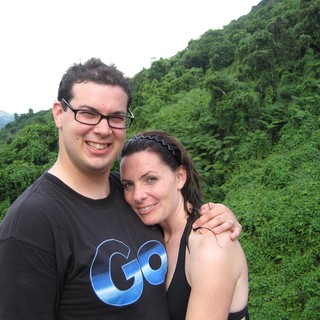 Couple Smiling Against Lush Fiji Jungle Hillside