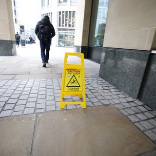Wet Floor Caution Sign in Modern Building Corridor