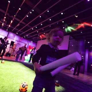 Toddler Dancing at Baby Rave Event with Purple Lights
