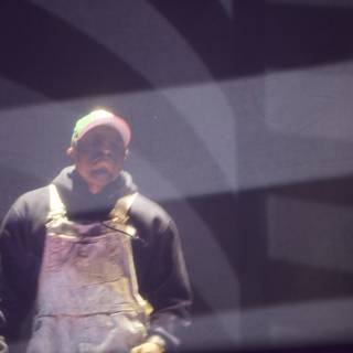 On Stage with Overalls and a Hat