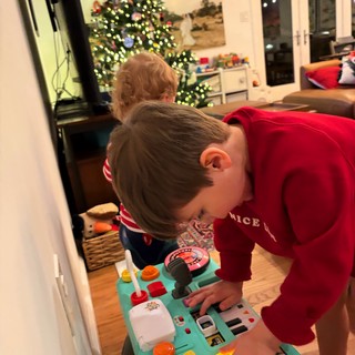 Children Playing with Activity Toy on Christmas Morning