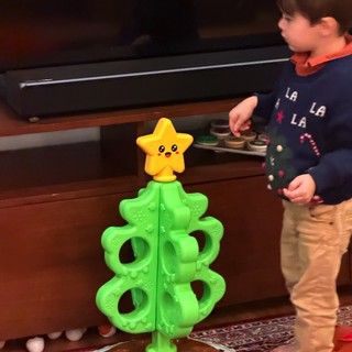 Child Playing with Christmas Tree Toy and Train Set