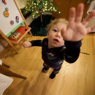 Toddler Reaching Toward Camera on Christmas Morning
