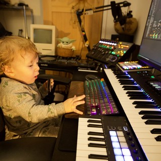 Young Child Exploring Music Production Studio Setup