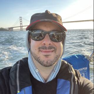 Man in Sunglasses and Hat Enjoys Scenic Boat Ride in San Francisco Bay