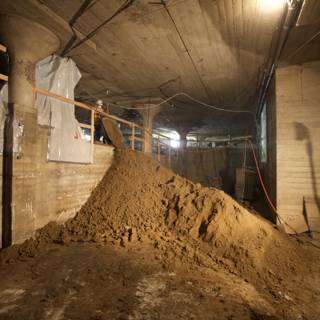 Sand Pile and Ladder in Basement Room