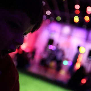 Silhouette Against Colorful Bokeh Lights at Baby Rave