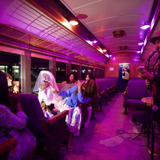 Theatrical Train Journey with Purple Lighting and Costumed Performers