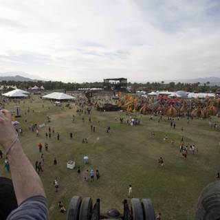 Capturing the Beat: Man Snaps Photo of Music Festival Crowd