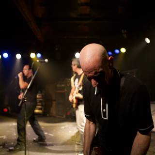 Rocking the Stage: A Bald Headed Guitarist in Bad Religion Glasshouse Concert