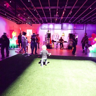 Child Playing at Vibrant Baby Rave Exhibition