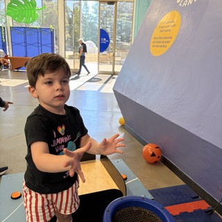 Young Boy Playing at Interactive Children's Museum Exhibit