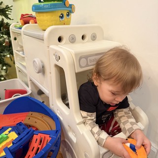 Toddler Playing with Toys in Baby Gate Enclosure