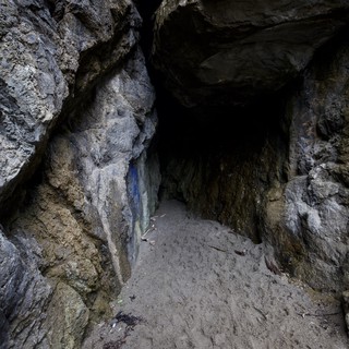 Dark Cave Entrance Framed by Ancient Rocky Walls