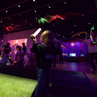 Child Wielding Glow Stick at Baby Rave Dance Party