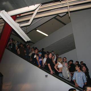 A Crowd of 31 People on a Staircase with Handrail