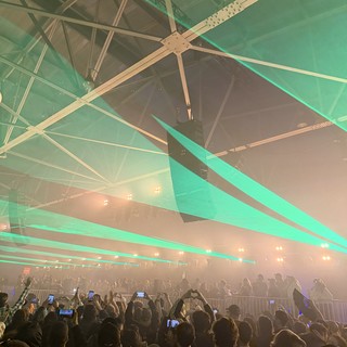 Concert Crowd Under Green Laser Light Show