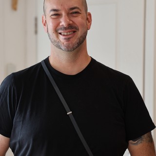 Warm Portrait of Smiling Man in Black T-Shirt