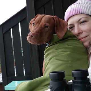 Woman and Dog Share Winter Moment Outdoors