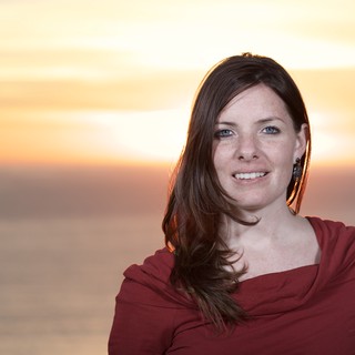 Woman Smiling at Golden Hour Ocean Sunset