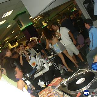 Nightclub Crowd Dancing to DJ's Mix