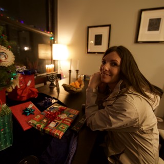 Smiling Woman Celebrates Hanukkah and Christmas Together