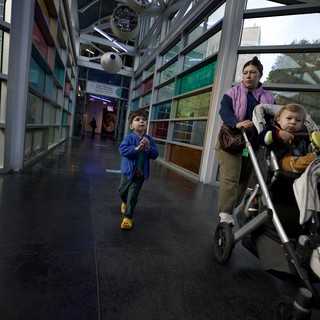 Family Explores Interactive Science Museum Corridor