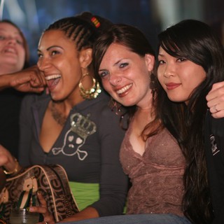 Three Friends Laughing Together at Nightclub Party
