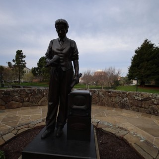 Bronze Statue of Woman with Suitcase at Memorial